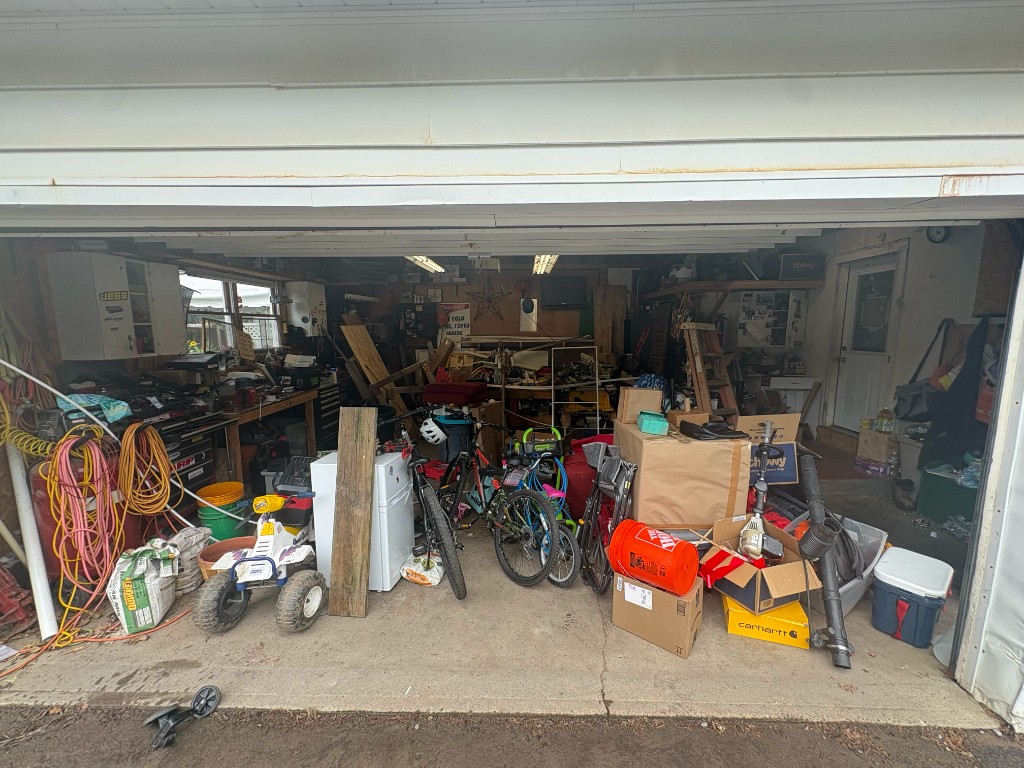 Cluttered garage before a Maverick Garage Reset cleanout.